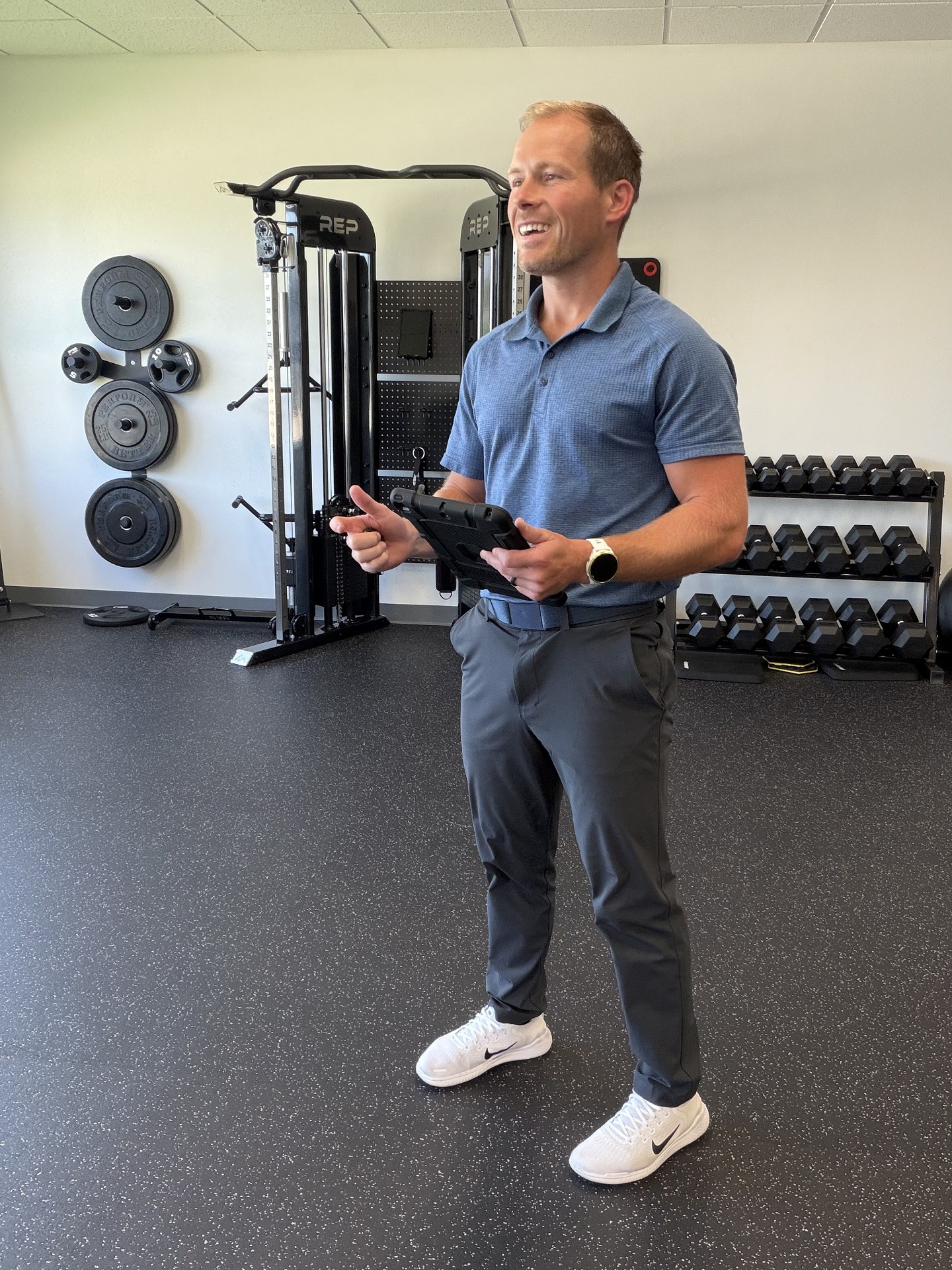 Ames Elite Fitness coach reviewing a training plan on a tablet